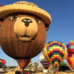 Colorful hot air balloons in the sky featuring various designs.
